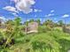 The backyard features an outbuilding near a fenced yard, with lush greenery at 2818 Olympic St, Sarasota, FL 34231