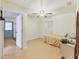 A bright bedroom features wood flooring, a ceiling fan, and a comfortable yellow bed at 2818 Olympic St, Sarasota, FL 34231