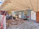 Carport with concrete flooring, showcasing ample space for vehicles and projects and multiple entry doors at 2818 Olympic St, Sarasota, FL 34231