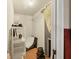 Walk-in closet area with hanging racks, storage shelves, and visible wooden flooring at 2818 Olympic St, Sarasota, FL 34231