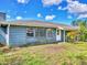 Quaint home exterior featuring a chimney, large windows, and front door with green space at 2818 Olympic St, Sarasota, FL 34231