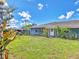 Home exterior featuring shed and greenery with a lush green lawn at 2818 Olympic St, Sarasota, FL 34231
