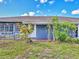 Exterior of home featuring windows, front door and brick landing surrounded by greenery at 2818 Olympic St, Sarasota, FL 34231