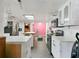 Kitchen with white cabinets, black appliances, and a skylight at 2818 Olympic St, Sarasota, FL 34231