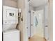Practical laundry area equipped with a stacked washer and dryer near the kitchen at 2818 Olympic St, Sarasota, FL 34231