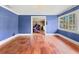 Living room with wood floors, blue walls, and a large window at 2818 Olympic St, Sarasota, FL 34231