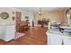Living room featuring a piano, chandelier and open access to kitchen at 2818 Olympic St, Sarasota, FL 34231