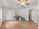 Open living room featuring wood floors, neutral walls, ceiling fan, and an open doorway to the kitchen at 2818 Olympic St, Sarasota, FL 34231
