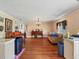Large living room featuring hardwood flooring, piano and window at 2818 Olympic St, Sarasota, FL 34231