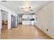 Spacious living room and kitchen combo featuring light wood floors and white cabinets at 2818 Olympic St, Sarasota, FL 34231