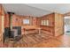 Cozy living room featuring wood paneling and a vintage-style wood-burning stove at 2818 Olympic St, Sarasota, FL 34231