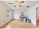 Inviting living room with hardwood floors, neutral walls, ceiling fan, and natural light from the window at 2818 Olympic St, Sarasota, FL 34231