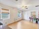 An empty living room with wood floors, featuring large windows and plenty of natural light at 2818 Olympic St, Sarasota, FL 34231