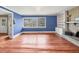 Living room with wood floors, blue walls, and a brick fireplace at 2818 Olympic St, Sarasota, FL 34231