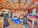 The outbuilding has a workbench and storage shelves under a metal roof at 2818 Olympic St, Sarasota, FL 34231