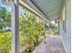 Covered porch featuring stone pavers and garden views at 2818 Olympic St, Sarasota, FL 34231
