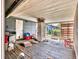 Enclosed sunroom needing repair, featuring screened windows and a view of the backyard at 2818 Olympic St, Sarasota, FL 34231