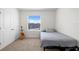 Bedroom with light carpet and walls with guitar next to window at 2824 Pearly Banks Dr, Bradenton, FL 34208