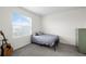 Bedroom with light gray walls, large window and acoustic guitar at 2824 Pearly Banks Dr, Bradenton, FL 34208
