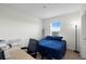 Bright bedroom featuring a comfortable bed, workspace, and a window with natural light at 2824 Pearly Banks Dr, Bradenton, FL 34208