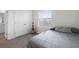 Bedroom with light gray walls, large window and closet with a guitar at 2824 Pearly Banks Dr, Bradenton, FL 34208