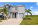 Two story townhome with a one car garage and a well manicured lawn with several trees at 2824 Pearly Banks Dr, Bradenton, FL 34208