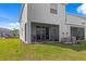 Rear view of the home featuring a screened lanai and well-maintained lawn at 2824 Pearly Banks Dr, Bradenton, FL 34208