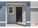 A close up exterior shot of the front door of this property with painted columns and a storm door at 2824 Pearly Banks Dr, Bradenton, FL 34208