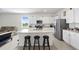 Bright, open kitchen features a granite island, white cabinets, and stainless steel appliances at 2824 Pearly Banks Dr, Bradenton, FL 34208