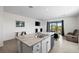 Modern kitchen features stainless steel appliances and an island with bar seating and views of the back patio at 2824 Pearly Banks Dr, Bradenton, FL 34208