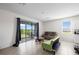 Bright living area featuring a sliding glass door to the porch and comfortable seating at 2824 Pearly Banks Dr, Bradenton, FL 34208