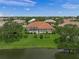Scenic aerial view of the property showcasing its lush landscaping and tranquil lakefront setting at 2937 Seasons Blvd, Sarasota, FL 34240