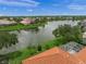 Aerial view showcases a waterfront property with lush landscaping and stunning community views at 2937 Seasons Blvd, Sarasota, FL 34240
