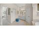 Elegant bathroom featuring a double vanity, linen closet, and tile floors at 2937 Seasons Blvd, Sarasota, FL 34240
