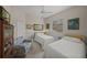 Charming bedroom with two twin beds, neutral walls, and a cozy sitting area at 2937 Seasons Blvd, Sarasota, FL 34240