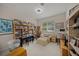 Inviting room features bookshelves, piano, and study area with natural light at 2937 Seasons Blvd, Sarasota, FL 34240