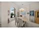 Bright dining room featuring a large window, chandelier lighting, and stylish decor at 2937 Seasons Blvd, Sarasota, FL 34240