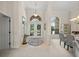 Elegant foyer with arched doorway, high ceilings, neutral walls, tile flooring, and views into adjacent dining area at 2937 Seasons Blvd, Sarasota, FL 34240