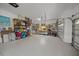 Spacious garage featuring epoxy flooring, ample storage, and workbench area at 2937 Seasons Blvd, Sarasota, FL 34240