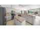 Modern kitchen featuring stainless appliances, an island, and views of the living area and backyard at 2937 Seasons Blvd, Sarasota, FL 34240