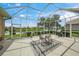 Screened lanai with patio furniture and scenic lake views, perfect for outdoor dining at 2937 Seasons Blvd, Sarasota, FL 34240