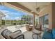 Relaxing lanai with comfortable seating and scenic views of the pond and landscaping at 2937 Seasons Blvd, Sarasota, FL 34240