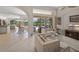 Open-concept living room with comfortable seating and an entertainment center, leading to an outdoor patio at 2937 Seasons Blvd, Sarasota, FL 34240