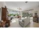 Bright living room with views to the screened lanai and backyard at 2937 Seasons Blvd, Sarasota, FL 34240