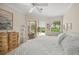 Peaceful main bedroom featuring a sliding door to the lanai, neutral colors, and dresser at 2937 Seasons Blvd, Sarasota, FL 34240