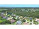 Aerial view of estate home surrounded by trees, waterways, and other large homes in the community at 2962 Wilderness E Blvd, Parrish, FL 34219