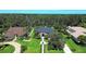Aerial view of a home with beautifully landscaped yard, trees, and proximity to a dense forest at 2962 Wilderness E Blvd, Parrish, FL 34219