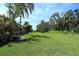 Expansive backyard featuring well-manicured lawn and lush trees with plenty of space for recreation and entertaining at 2962 Wilderness E Blvd, Parrish, FL 34219