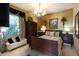Comfortable bedroom featuring a decorative chandelier, a dark wooden armoire, and large window for natural light at 2962 Wilderness E Blvd, Parrish, FL 34219