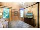 Bedroom showcasing a four poster bed, chandelier, and bright windows at 2962 Wilderness E Blvd, Parrish, FL 34219